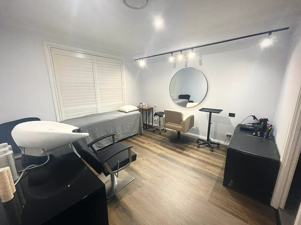 Bright home salon with HBS Basin, bed and styling chair